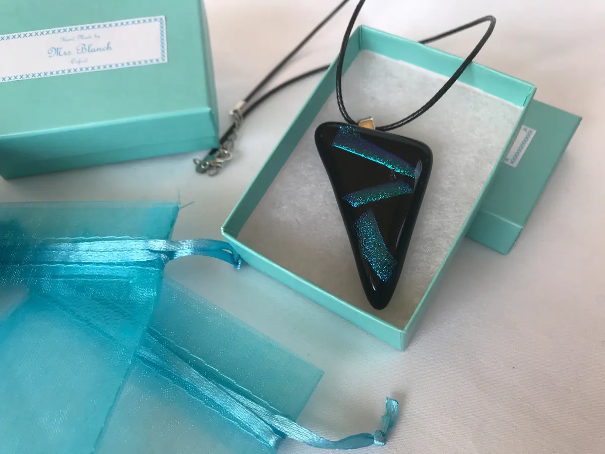 Black triangular pendant with purple/turquoise/green dichroic stripes P004