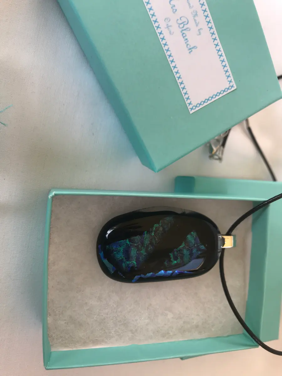Black background with blue/green textured dichroic decoration P008
