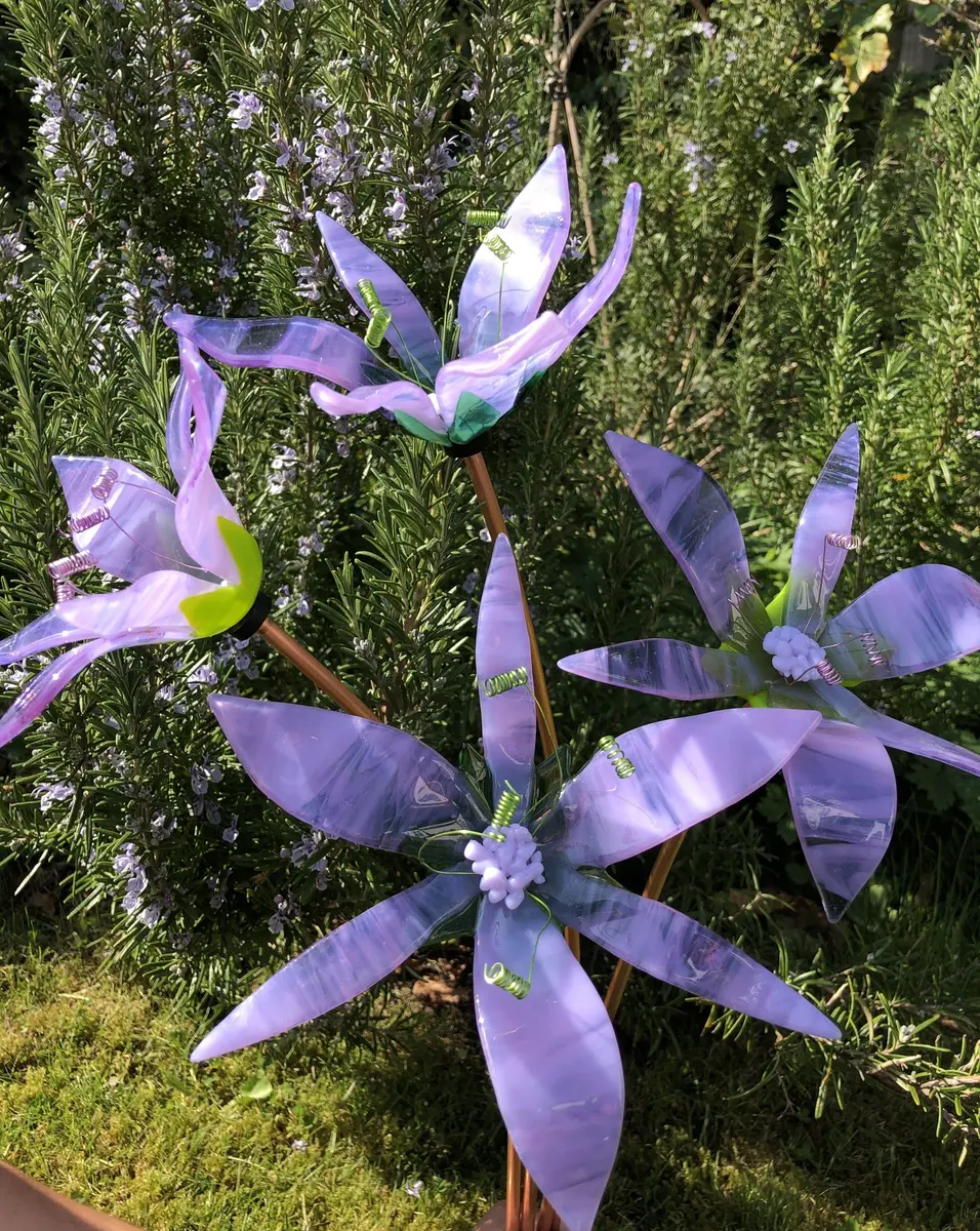 Fused Glass purple and white streaky lilies approx 15-20cm across and approx 40cm high. On copper stem. Purple or green stamen. £45.00 each.