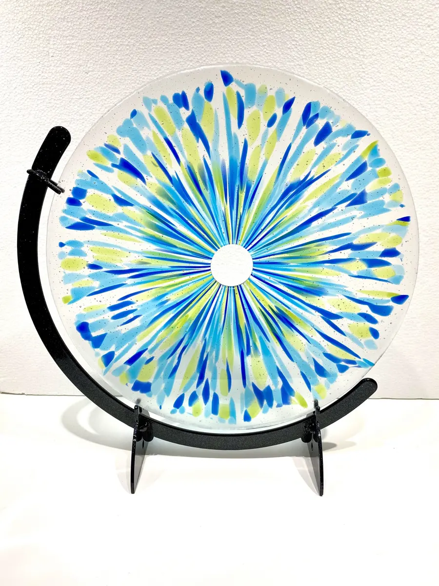 Glass "polo" in green and blues. Approx 30cm diameter in a black stand. £80.00