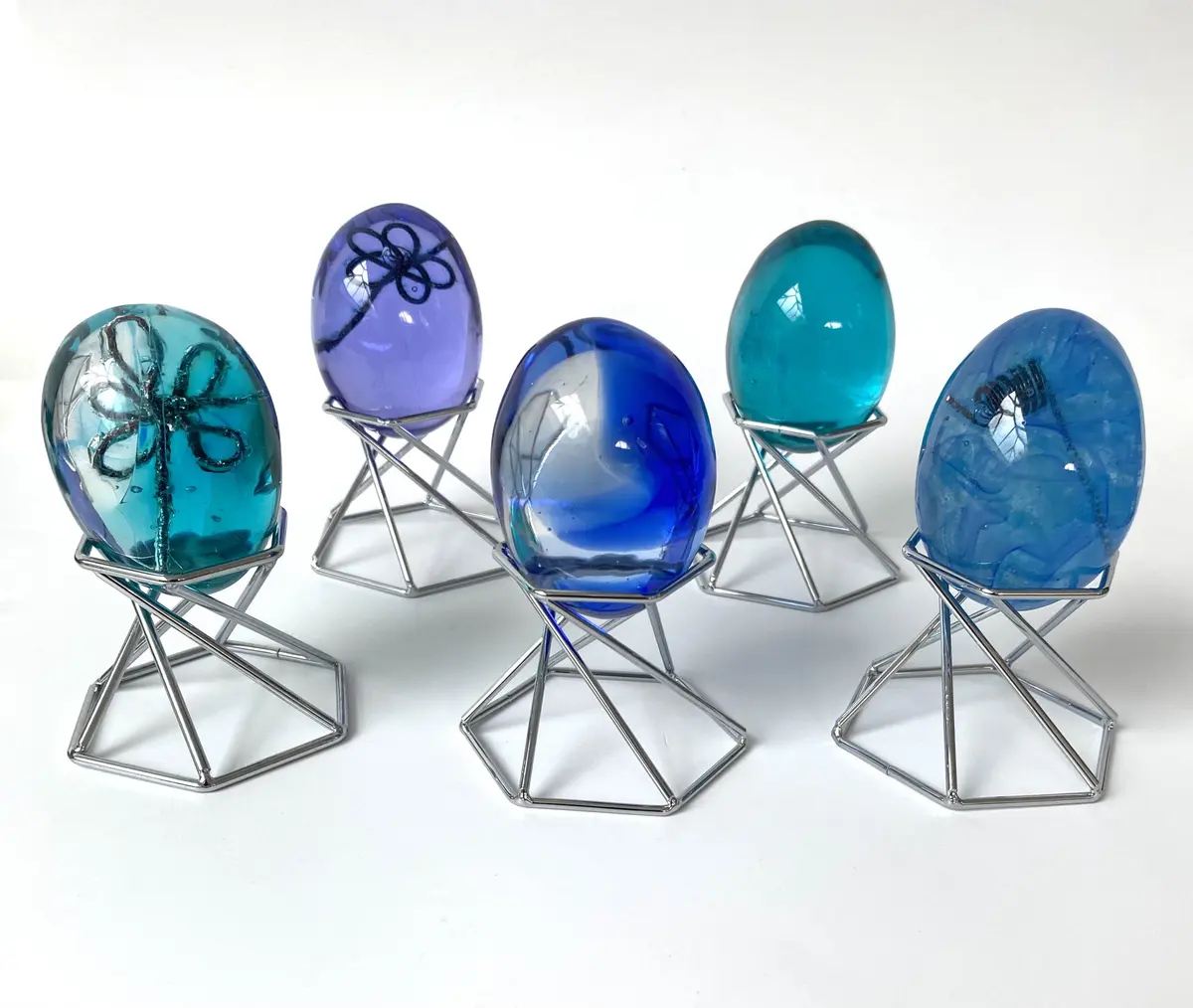 Cast glass eggs with metal infusions to give additional interest. Egg sized - a real egg was used to make the model for the cast.