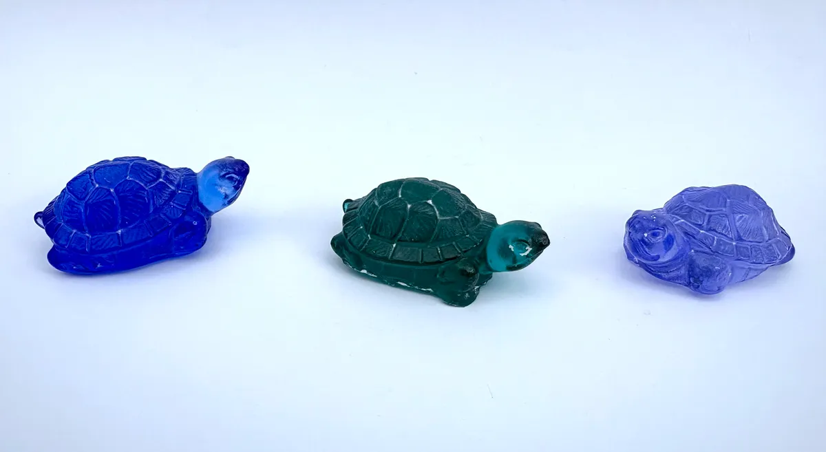 Three glass turtles in cobalt, teal and lavender